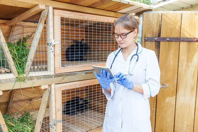 Portrait of young female doctor standing in factory