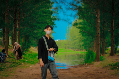 Full length of young man walking in forest