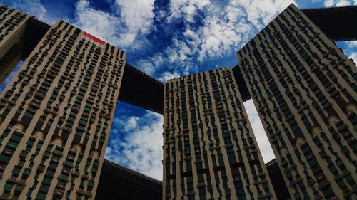 Low angle view of building against cloudy sky