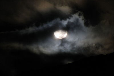 Low angle view of cloudy sky at night