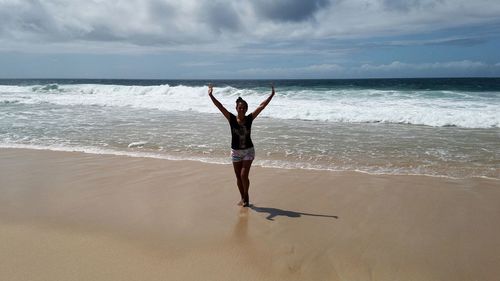 Rear view of person walking on beach