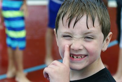 Close-up portrait of wet smiling boy 