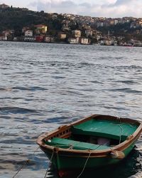 Boat moored on sea against sky