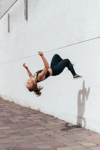 Full length of woman doing backflip