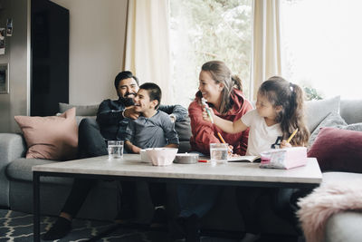 Happy family spending leisure time in living room