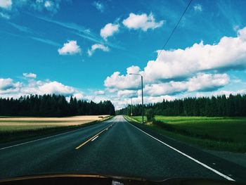 Road passing through landscape against sky
