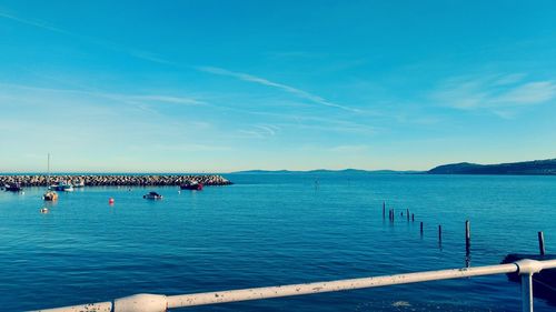 Scenic view of sea against blue sky