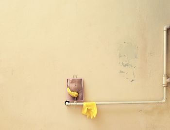 Midsection of naked woman reflecting in mirror on wall