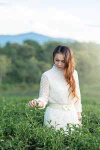 Happy woman standing on field