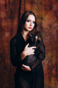 Portrait of teenage girl holding cat