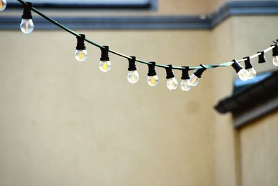 Low angle view of illuminated light bulbs hanging