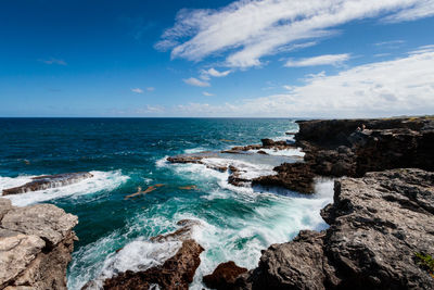 Scenic view of sea against blue sky