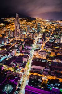 Aerial view of illuminated buildings in city at night