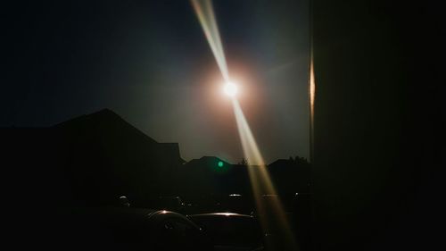 View of illuminated ferris wheel against sky at night