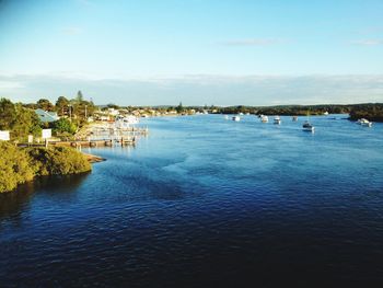 Scenic view of sea by buildings against sky