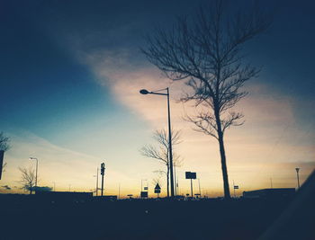 Low angle view of silhouette bare trees against sky