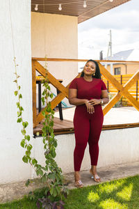 Full length of young woman sitting on staircase