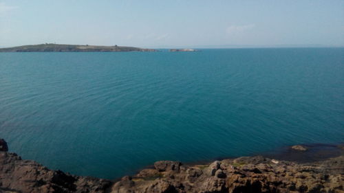 Scenic view of sea against blue sky