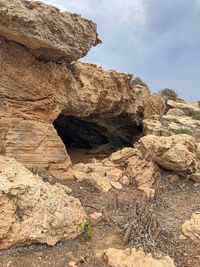 Low angle view of rock formations against sky