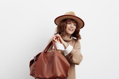 Young woman wearing hat against white background