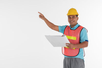 Man holding umbrella against white background