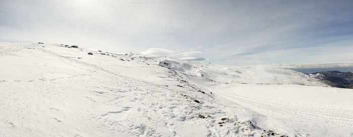 Scenic view of snow covered mountain against sky