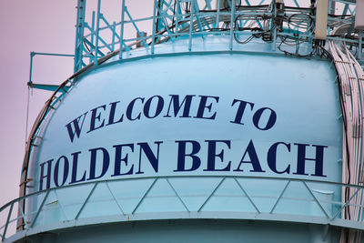 Low angle view of information sign on metal structure