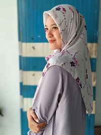 Cropped hand of woman standing by railing