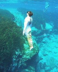 High angle view of woman swimming in sea