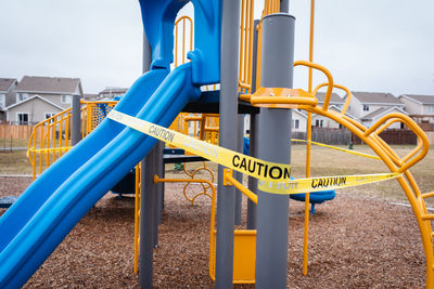Playground equipment wrapped in caution tape during covid 19 pandemic.