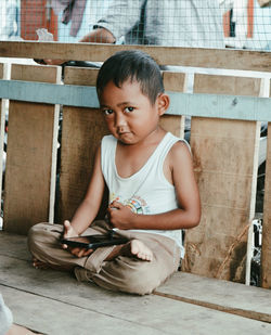 Side view of boy looking at camera