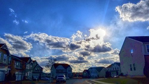 Panoramic view of houses against blue sky