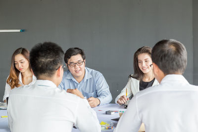 High angle view of friends sitting on table