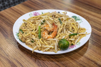 High angle view of fried prawn noodles served on table