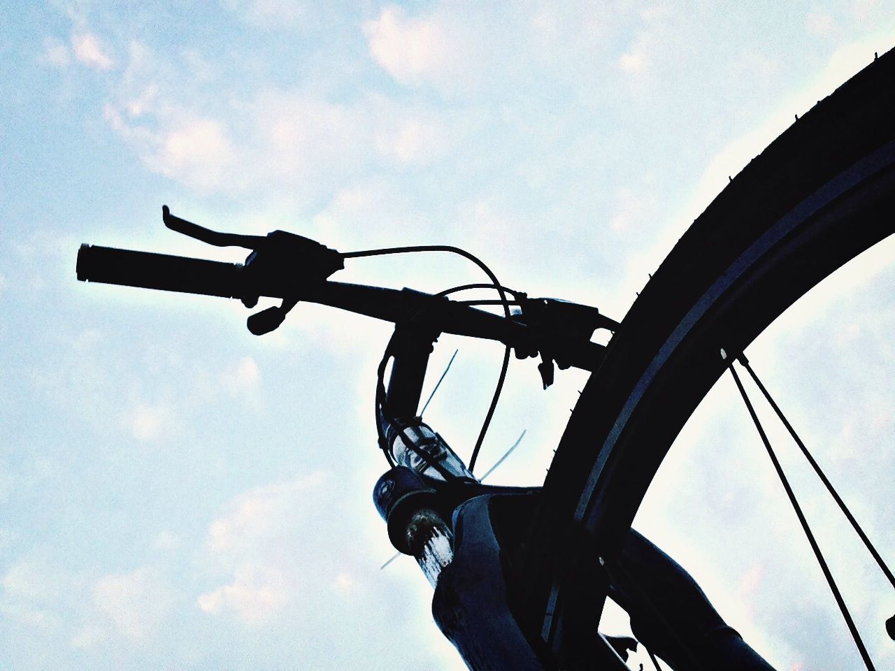 low angle view, sky, transportation, silhouette, mode of transport, cloud - sky, leisure activity, men, airplane, cloud, air vehicle, travel, lifestyles, mid-air, technology, extreme sports, day, outdoors