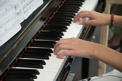 Teenage girl playing the piano in the classroom, music hobby