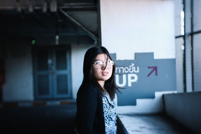 Portrait of young woman standing outdoors