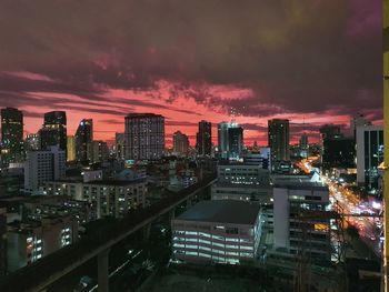 High angle view of illuminated buildings against sky at night