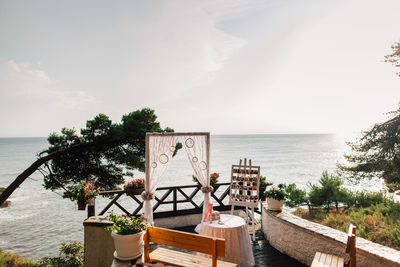 Built structure on table by sea against sky