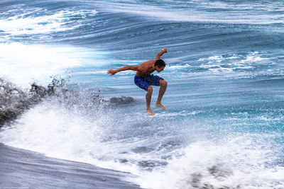 Woman jumping in sea