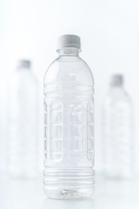 Close-up of glass bottle against white background