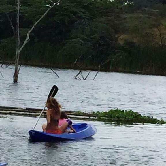 MAN SITTING IN BOAT AT RIVER