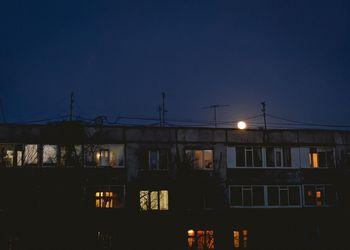 Low angle view of illuminated building against sky at night