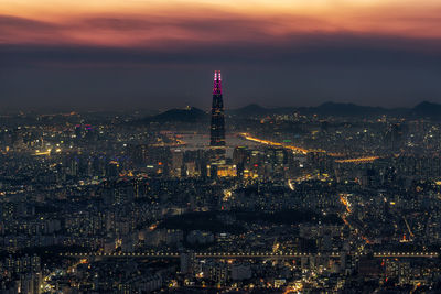 Aerial view of illuminated city buildings at night