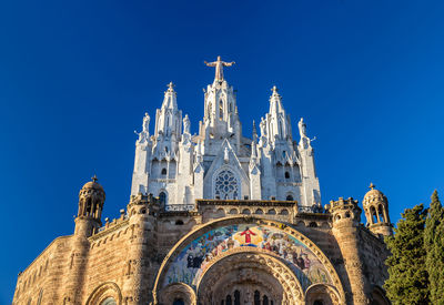 Low angle view of building against blue sky