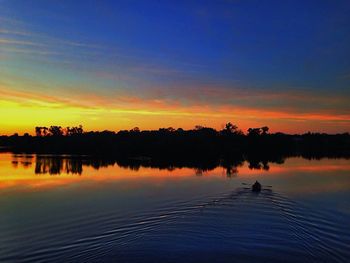 Scenic view of lake at sunset