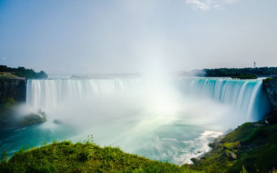 Scenic view of waterfall, nigara falls with rainbow 