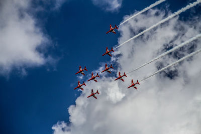 Low angle view of airshow against sky