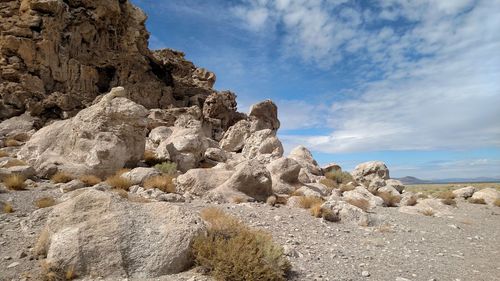 Rocks on landscape against sky