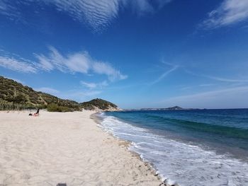 Scenic view of beach against blue sky